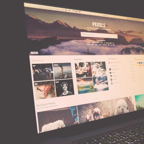 Laptop screen showing Pexels website, ideal for stock photo needs.